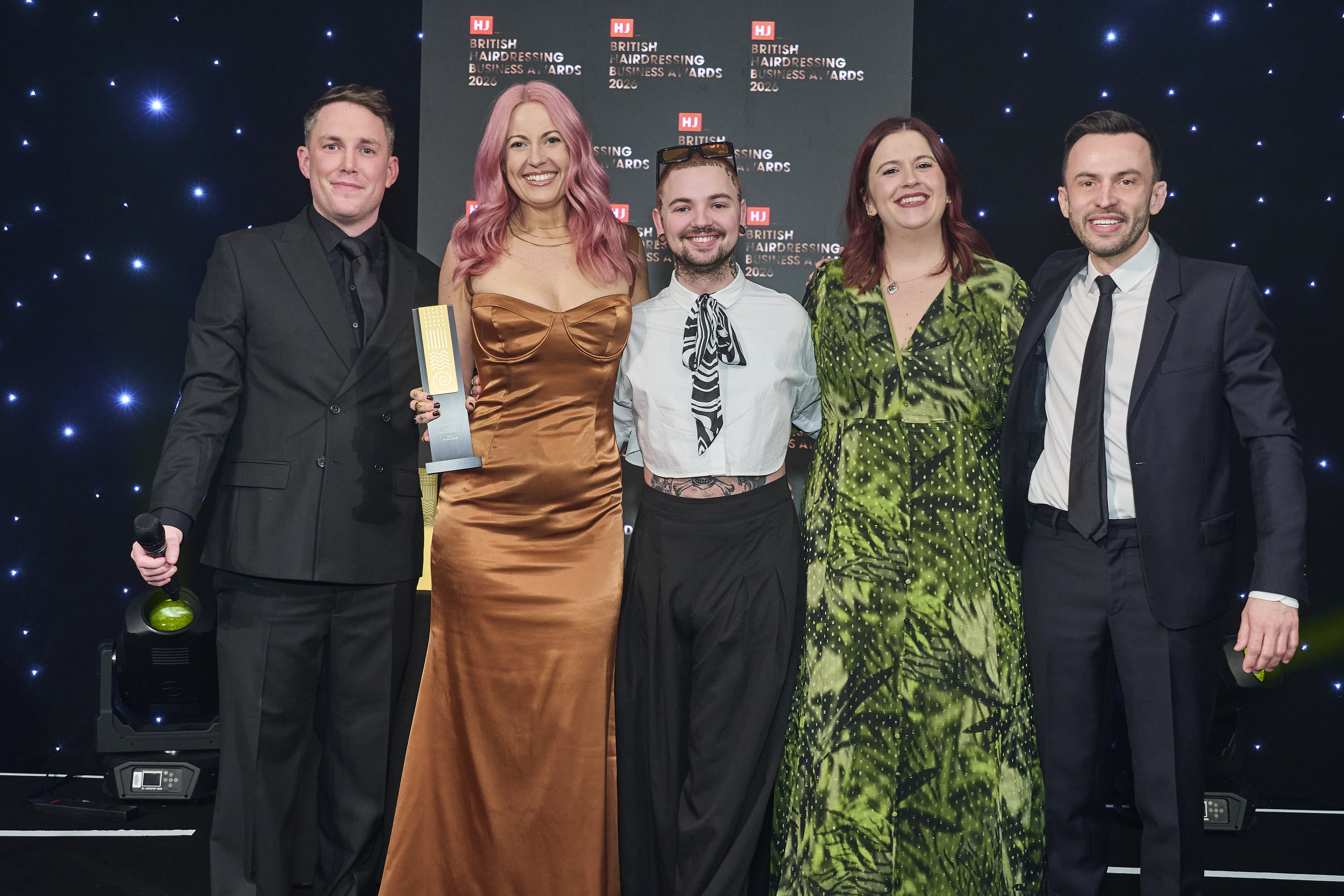 Chloe and Lew receiving the award on stage at the British hairdressing business awards