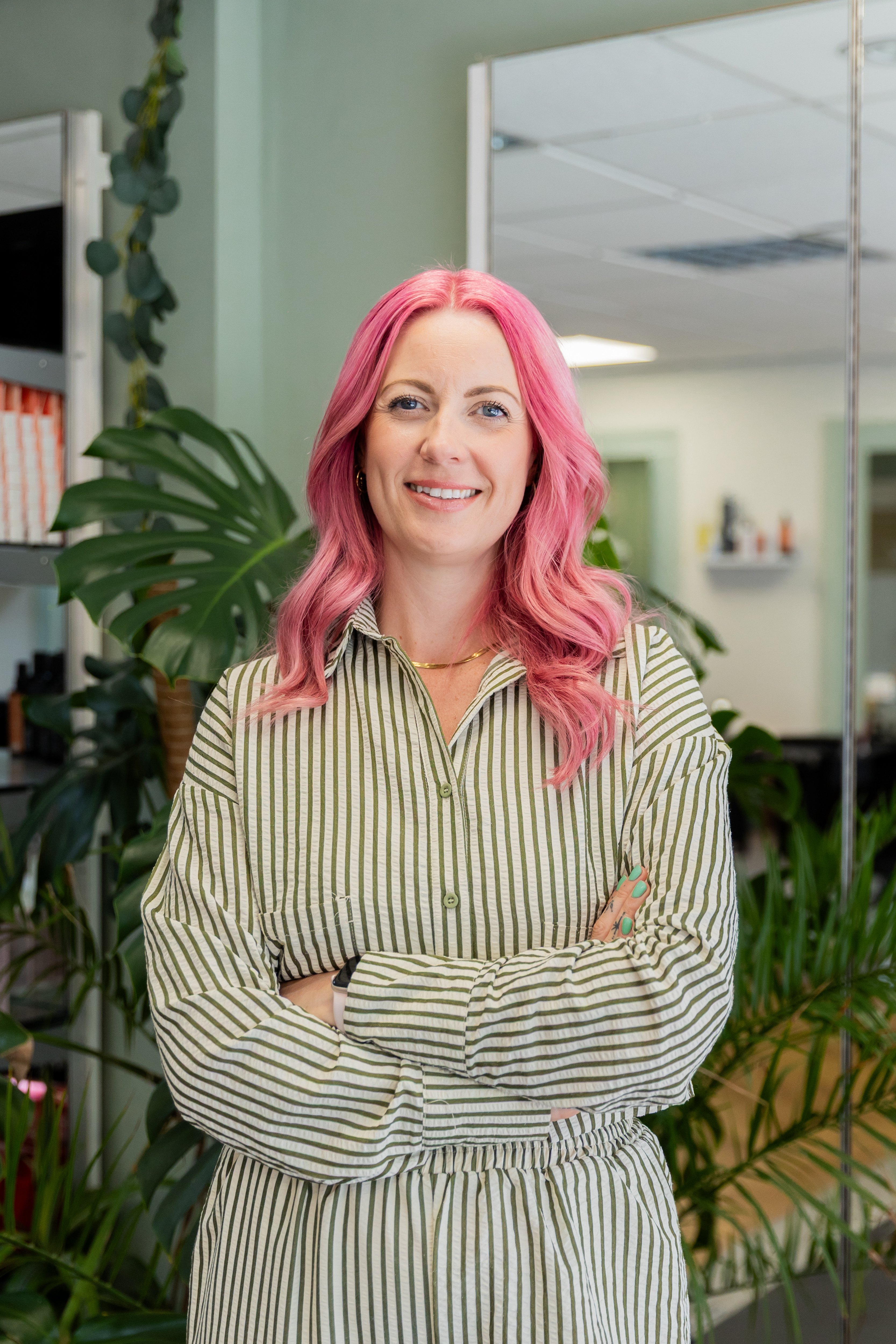 Chloe standing in the salon, arms crossed.