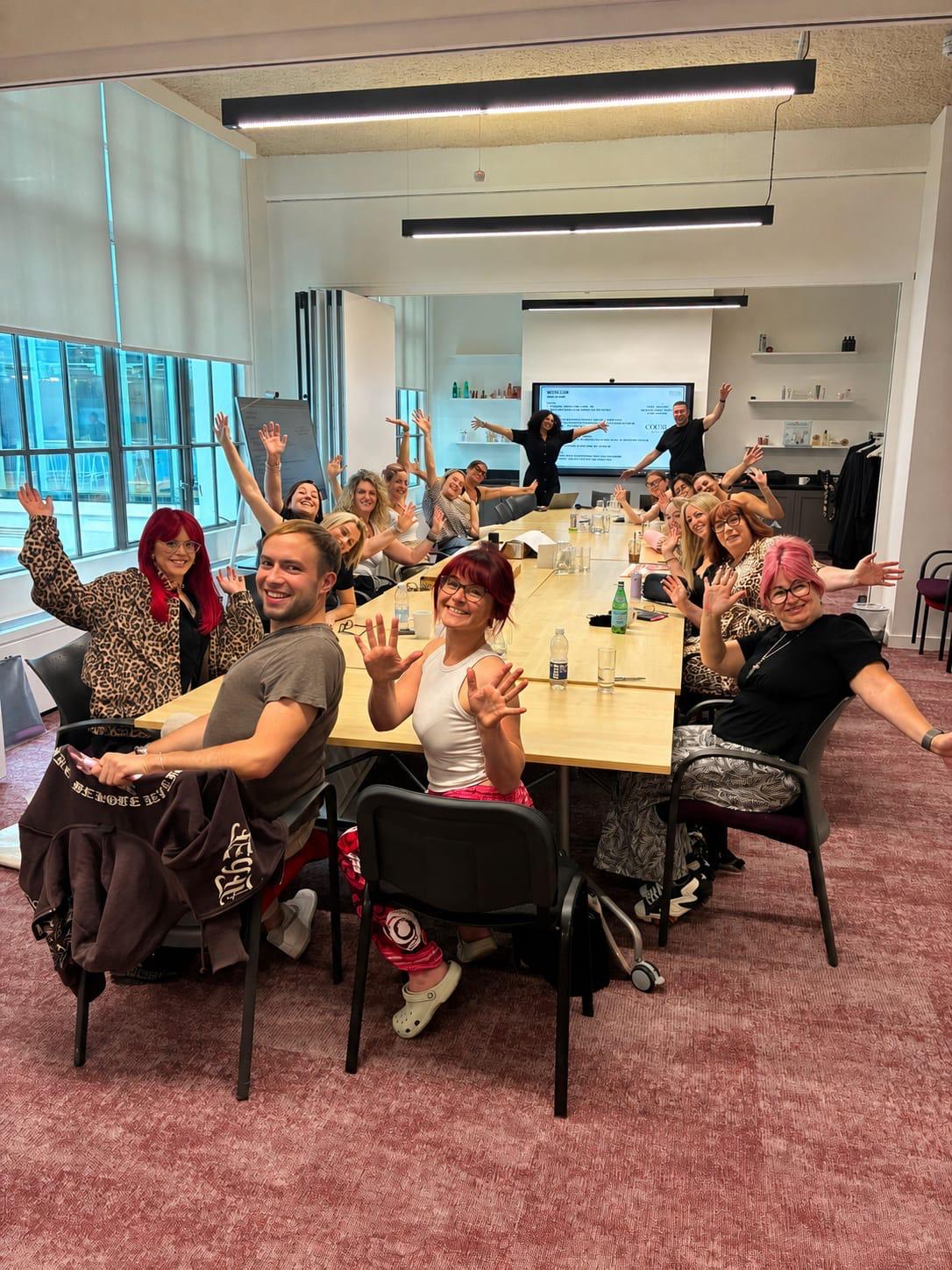 cohort of students celebrating in classroom